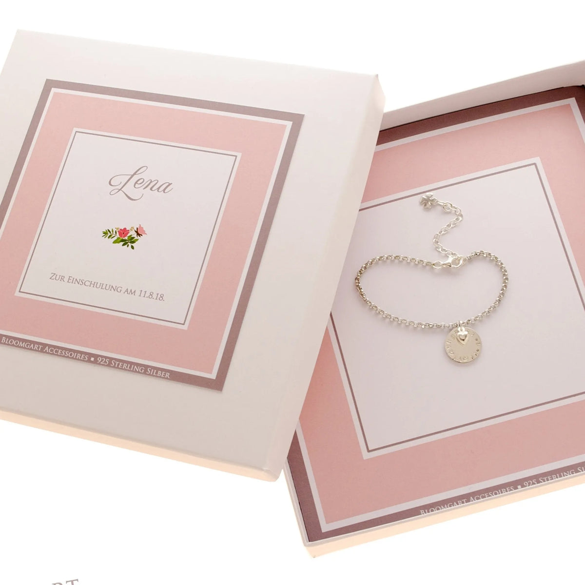 Rosa-weiße Geschenkbox personalisiert für 'Lena' zur Einschulung mit Namensarmband aus 925 Silber innenliegend.