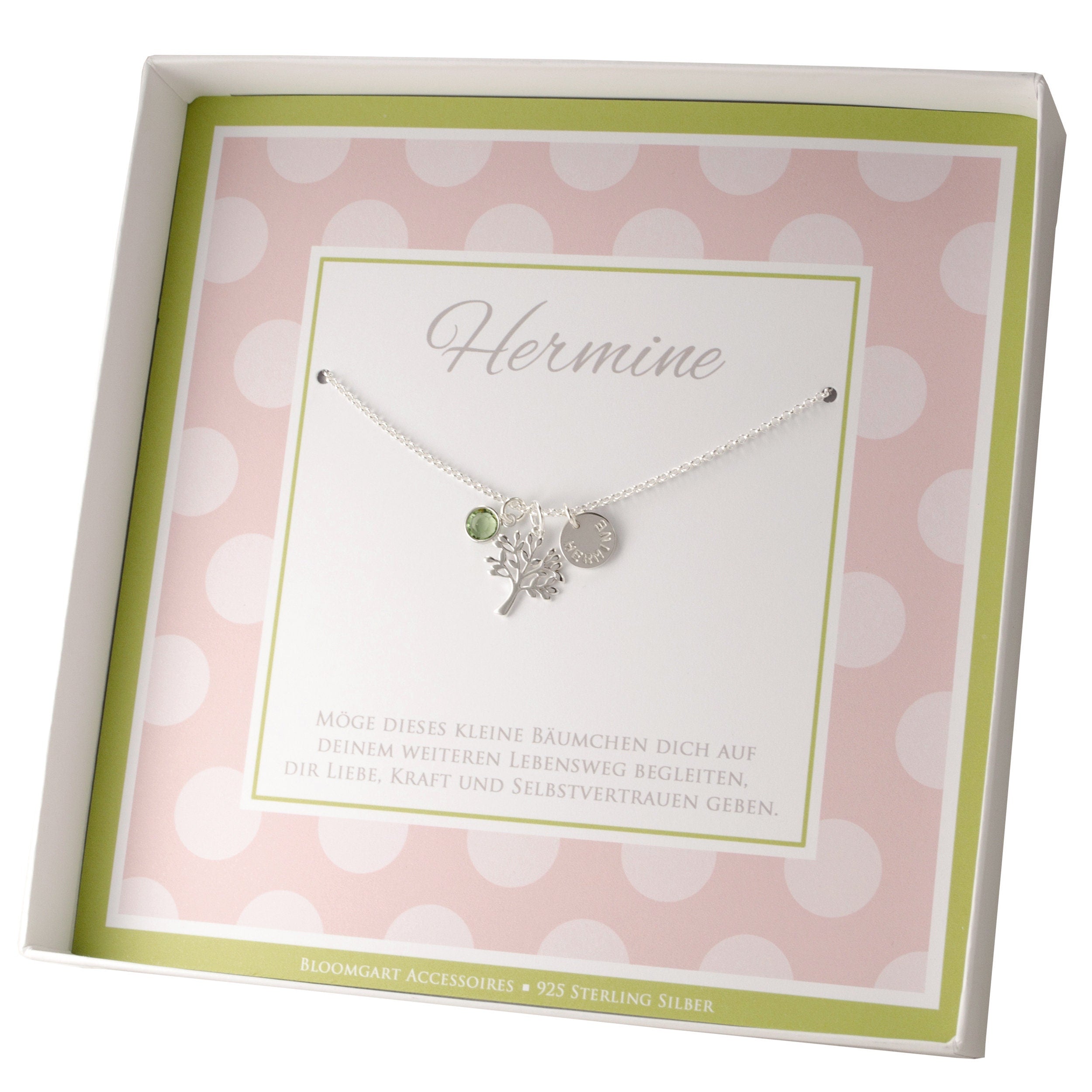 Innenansicht einer Geschenkbox in rosa-grün mit personalisierter Lebensbaum-Kette aus 925 Silber mit Namensgravur und peridot grünem Geburtsstein, präsentiert in einer Geschenkbox mit Spruch: "Möge dieses Bäumchen dich auf deinem weiteren Lebensweg..."