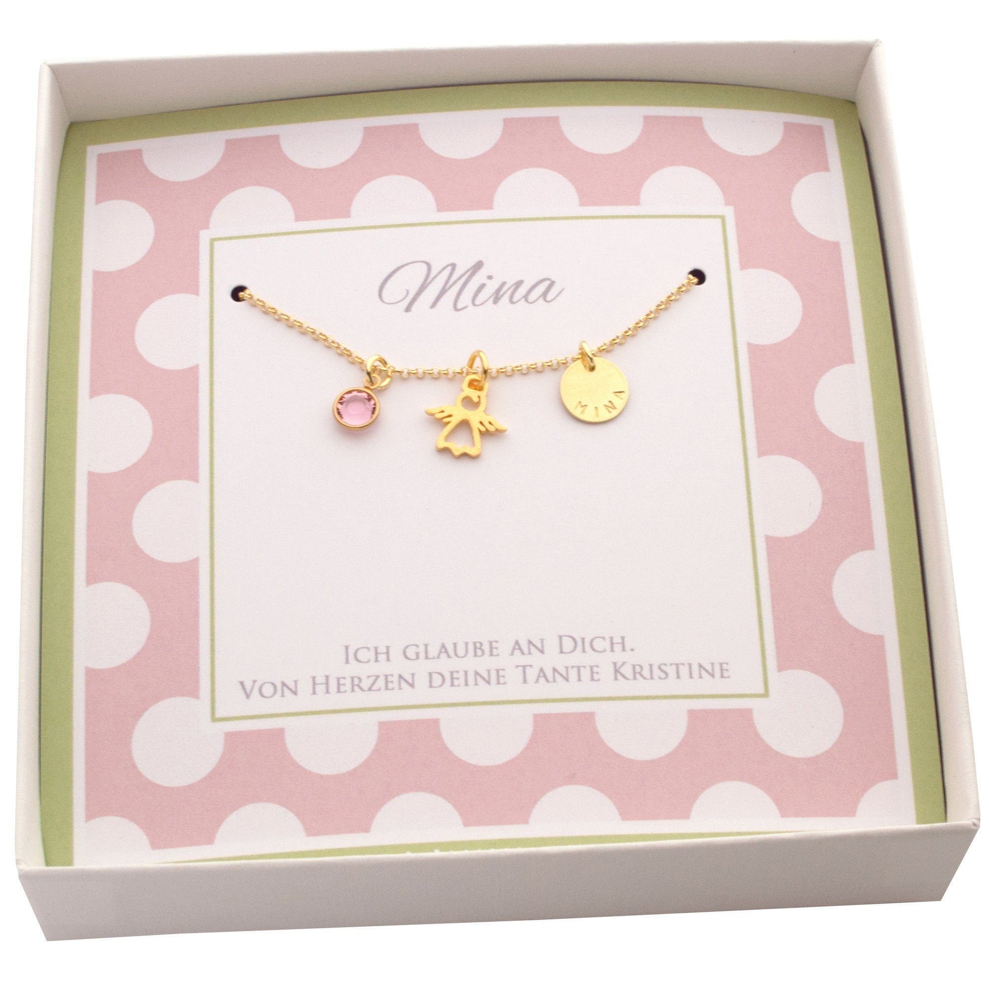 Innenansicht der Geschenkbox mit goldener Schutzengelkette, personalisiert für 'Mina' und den Wünschen unter der Kette: 'Ich glaube an dich. Von Herzen deine Tante Kristine'